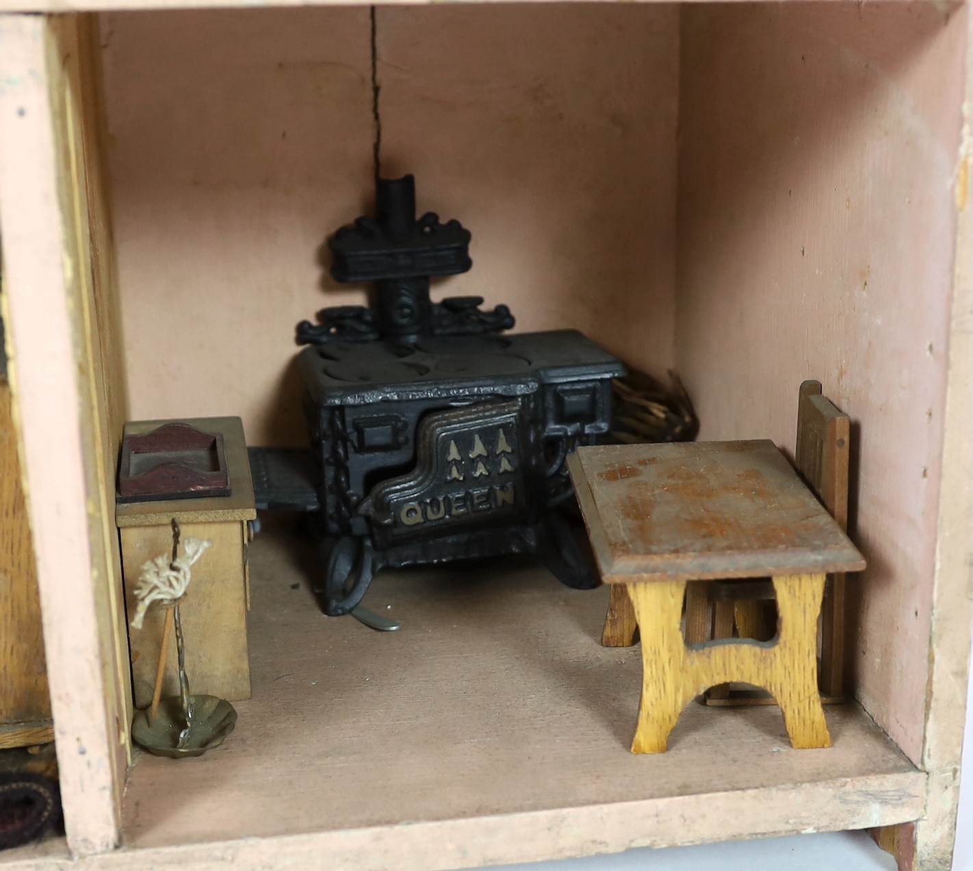 A Victorian furnished dolls’ house, circa 1890, 77cm high.